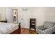 Cozy bedroom with hardwood floors, decorative chair, and view to additional rooms and closet at 706 Hillcrest St, Orlando, FL 32803