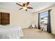 Cozy bedroom showcasing a ceiling fan, natural light, and neutral decor at 706 Hillcrest St, Orlando, FL 32803