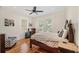 Spacious bedroom with plantation shutters, wood floors, ceiling fan, and natural light at 706 Hillcrest St, Orlando, FL 32803