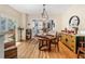 Inviting dining room boasts hardwood floors, stylish decor, and ample natural light with an open view into the kitchen at 706 Hillcrest St, Orlando, FL 32803