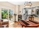 Warm dining room featuring hardwood floors, stylish lighting, with a view to a serene outdoor deck and lush foliage at 706 Hillcrest St, Orlando, FL 32803