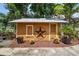 Charming exterior view of a tan, one-story home with a metal roof and landscaped yard, decorated with a decorative star at 706 Hillcrest St, Orlando, FL 32803