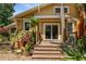 Back of house and deck surrounded by lush landscaping, featuring a sliding glass door for outdoor living at 706 Hillcrest St, Orlando, FL 32803