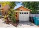 Detached garage with wooden doors and house number, next to foliage and trash cans at 706 Hillcrest St, Orlando, FL 32803
