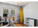 Bright room with yard access, hardwood floors, and surfboard decor at 706 Hillcrest St, Orlando, FL 32803