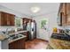 Updated kitchen with stainless steel appliances, stone countertops, and tile flooring at 706 Hillcrest St, Orlando, FL 32803