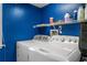 Functional laundry area with modern machines and storage shelving at 706 Hillcrest St, Orlando, FL 32803