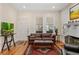 Cozy living room features hardwood floors, a fireplace, large windows, and a comfortable leather couch at 706 Hillcrest St, Orlando, FL 32803