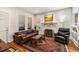 Bright living room featuring hardwood floors, a fireplace, and comfortable seating with ample natural light at 706 Hillcrest St, Orlando, FL 32803