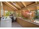 Charming screened-in porch with laundry area and a view of vibrant tropical landscaping at 706 Hillcrest St, Orlando, FL 32803