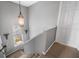 Staircase features overhead pendant lighting and natural light from a nearby window at 706 Hillcrest St, Orlando, FL 32803