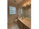 Bathroom featuring a sink, toilet, and a large mirror at 7147 Yacht Basin # 132, Orlando, FL 32835