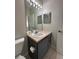 Bathroom vanity with a large mirror, and decorative lighting fixture at 7147 Yacht Basin # 132, Orlando, FL 32835
