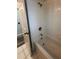 Bathroom featuring a bathtub and shower with tiled walls at 7147 Yacht Basin # 132, Orlando, FL 32835