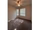 Carpeted bedroom features a ceiling fan and two windows that provide natural light at 7147 Yacht Basin # 132, Orlando, FL 32835
