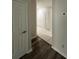 This hallway offers wood flooring, and white doors and trim at 7147 Yacht Basin # 132, Orlando, FL 32835