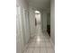 This hallway has tile flooring and a closet with louvered doors at 7147 Yacht Basin # 132, Orlando, FL 32835