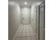 Tiled hallway featuring neutral walls, a front door, and closet at 7147 Yacht Basin # 132, Orlando, FL 32835