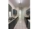 Spacious kitchen with gray cabinets, stainless appliances, and a window pass-through at 7147 Yacht Basin # 132, Orlando, FL 32835
