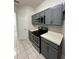 Kitchen with gray cabinets, stainless steel appliances, and white countertops at 7147 Yacht Basin # 132, Orlando, FL 32835
