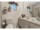 Well-lit bathroom with vanity, toilet, and shower with neutral accents at 7951 Chediston Cir, Orlando, FL 32817