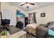 Cozy bedroom with neutral walls, ceiling fan, a workspace, and a comfortable bed at 7951 Chediston Cir, Orlando, FL 32817