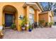 Inviting front porch with decorative tile, plants and decor at 7951 Chediston Cir, Orlando, FL 32817