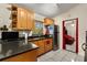View of updated kitchen with stainless steel appliances and dark countertops at 7951 Chediston Cir, Orlando, FL 32817