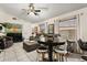 Inviting living room with a pub table, gray sectional and white tile flooring at 7951 Chediston Cir, Orlando, FL 32817
