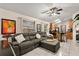 Spacious living room featuring a comfortable sectional, ceiling fan and lots of light at 7951 Chediston Cir, Orlando, FL 32817