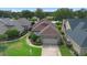 Charming single-story home featuring brick accents, manicured landscaping, and a two-car garage, all near a serene lake at 842 Bentley Green Cir, Winter Springs, FL 32708