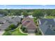 Beautiful aerial view of a home with a well-maintained lawn near a tranquil lake surrounded by lush greenery at 842 Bentley Green Cir, Winter Springs, FL 32708