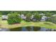 Scenic aerial view of homes backing onto a serene lake with lush greenery and mature trees at 842 Bentley Green Cir, Winter Springs, FL 32708