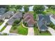 Beautiful aerial view of a home with a well-maintained lawn near a tranquil lake surrounded by lush greenery at 842 Bentley Green Cir, Winter Springs, FL 32708