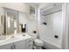 Well-lit bathroom featuring a shower-tub combo with a white tile surround, a vanity with a mirror, and plantation shutters at 842 Bentley Green Cir, Winter Springs, FL 32708