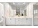 Bright bathroom with dual sinks, white cabinets, and large mirror at 842 Bentley Green Cir, Winter Springs, FL 32708