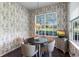 Cozy breakfast nook featuring charming wallpaper, a round table, and a view of the outdoors at 842 Bentley Green Cir, Winter Springs, FL 32708