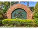 Elegant brick and tile community sign with manicured landscaping at 842 Bentley Green Cir, Winter Springs, FL 32708