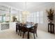 Elegant dining room with a chandelier, large table, and built-in display shelves at 842 Bentley Green Cir, Winter Springs, FL 32708