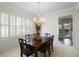 Traditional dining room with a wood table set for six and adorned with a classic chandelier at 842 Bentley Green Cir, Winter Springs, FL 32708