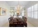 Elegant dining room with a chandelier, large table, and built-in display shelves at 842 Bentley Green Cir, Winter Springs, FL 32708