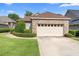 Charming single-story brick home with a two-car garage and well-manicured landscaping at 842 Bentley Green Cir, Winter Springs, FL 32708