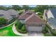 Inviting home with manicured shrubs, brick accents, a two-car garage, and picturesque lake views in a desirable location at 842 Bentley Green Cir, Winter Springs, FL 32708