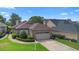 Inviting home with manicured shrubs, brick accents, a two-car garage, and picturesque lake views in a desirable location at 842 Bentley Green Cir, Winter Springs, FL 32708