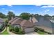 Charming single-story home featuring brick accents, manicured landscaping, and a two-car garage, all near a serene lake at 842 Bentley Green Cir, Winter Springs, FL 32708