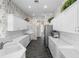 Bright and modern kitchen with white cabinets, white countertops, stainless steel appliances, and unique wallpaper at 842 Bentley Green Cir, Winter Springs, FL 32708