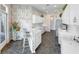 Elegant kitchen with white cabinetry, stone floors, stainless appliances, and a cozy breakfast bar at 842 Bentley Green Cir, Winter Springs, FL 32708