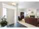 Inviting living room with fireplace, leather furniture, and ample natural light streaming in at 842 Bentley Green Cir, Winter Springs, FL 32708