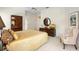 Spacious bedroom featuring a ceiling fan, unique wood armoire, and seating area at 842 Bentley Green Cir, Winter Springs, FL 32708