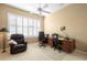 Bright office with a ceiling fan, a large window with shutters, a desk with office chairs, and a comfortable leather armchair at 842 Bentley Green Cir, Winter Springs, FL 32708